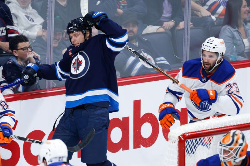 Sep 25, 2024; Winnipeg, Manitoba, CAN; Winnipeg Jets forward Vladislav Namestnikov (7) is hit by Edmonton Oilers forward Seth Griffith (23) during the third period at Canada Life Centre. Mandatory Credit: Terrence Lee-Imagn Images