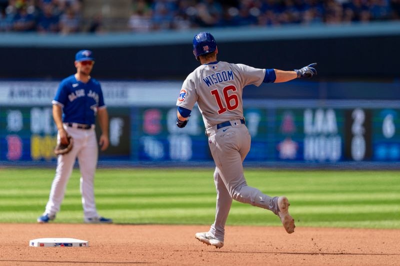 Aug 13, 2023; Toronto, Ontario, CAN; Chicago Cubs third baseman Patrick Wisdom (16) celebrates after hitting a home run against the Toronto Blue Jays during the seventh inning at Rogers Centre. Mandatory Credit: Kevin Sousa-USA TODAY Sports