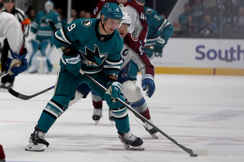 Nov 1, 2025; San Jose, California, USA; San Jose Sharks defenseman Dmitry Orlov (9) controls the puck against the Colorado Avalanche during the first period at SAP Center at San Jose. Mandatory Credit: Dennis Lee-Imagn Images
