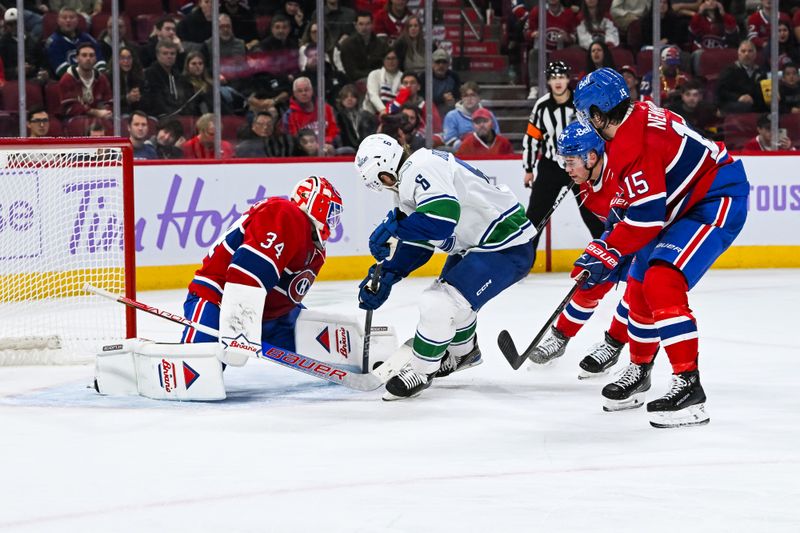 Nov 12, 2023; Montreal, Quebec, CAN; Montreal Canadiens goalie Jake Allen (34) makes a save against Vancouver Canucks right wing Brock Boeser (6) during the third period at Bell Centre. Mandatory Credit: David Kirouac-USA TODAY Sports