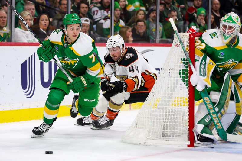 Jan 27, 2024; Saint Paul, Minnesota, USA; Minnesota Wild defenseman Brock Faber (7) and Anaheim Ducks left wing Ross Johnston (44) compete for the puck as goaltender Filip Gustavsson (32) defends his net during the second period at Xcel Energy Center. Mandatory Credit: Matt Krohn-USA TODAY Sports