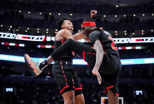 TORONTO, ON - DECEMBER 23: Scottie Barnes #4 and Chris Boucher #25 of the Toronto Raptors celebrate against the Utah Jazz during the first half of their basketball game at the Scotiabank Arena on December 23, 2023 in Toronto, Ontario, Canada. NOTE TO USER: User expressly acknowledges and agrees that, by downloading and/or using this Photograph, user is consenting to the terms and conditions of the Getty Images License Agreement. (Photo by Mark Blinch/Getty Images)