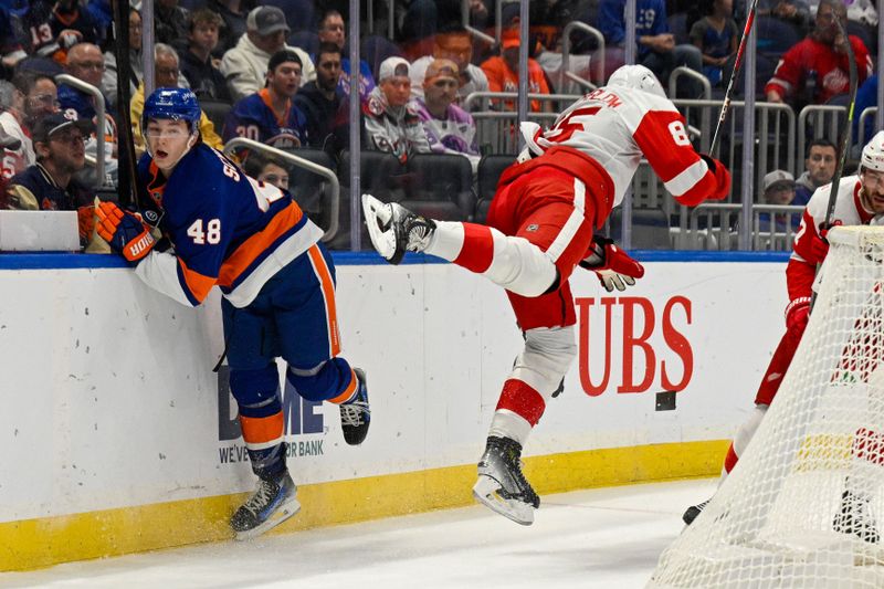 Oct 23, 2025; Elmont, New York, USA;  Detroit Red Wings left wing Elmer Soderblom (85) and New York Islanders defenseman Matthew Schaefer (48) collide behind the net during the first period at UBS Arena. Mandatory Credit: Dennis Schneidler-Imagn Images