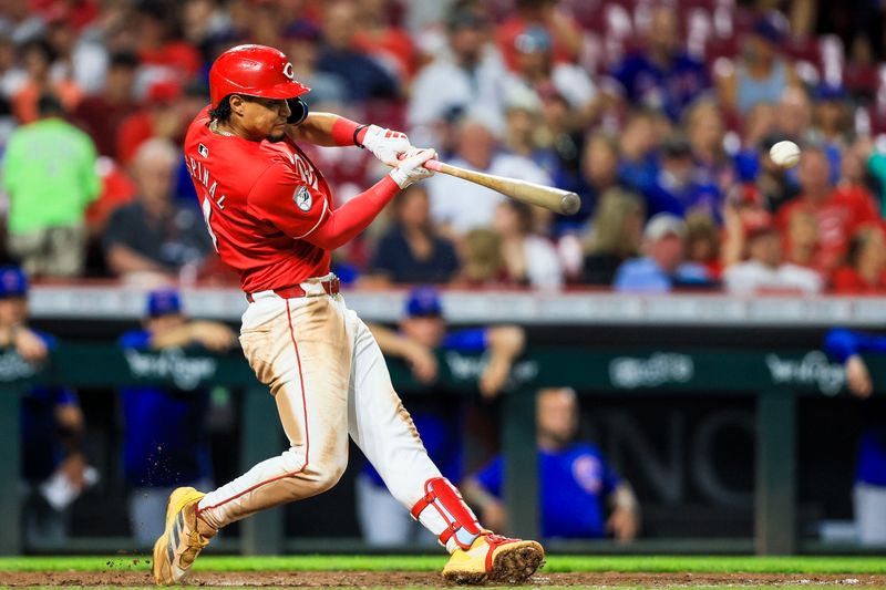 Jul 31, 2024; Cincinnati, Ohio, USA; Cincinnati Reds third baseman Santiago Espinal (4) hits a double in the eighth inning against the Chicago Cubs at Great American Ball Park. Mandatory Credit: Katie Stratman-USA TODAY Sports