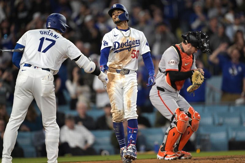 Apr 2, 2024; Los Angeles, California, USA; Los Angeles Dodgers shortstop Mookie Betts (50) is congratulated by designated hitter Shohei Ohtani (17) after hitting a solo home run for his 1500th career hit in the third inning against the San Francisco Giants at Dodger Stadium. Mandatory Credit: Jayne Kamin-Oncea-USA TODAY Sports