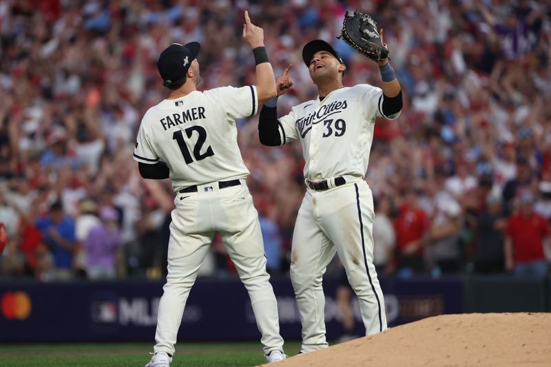 Oct 3, 2023; Minneapolis, Minnesota, USA; Minnesota Twins third baseman Kyle Farmer (12) and first baseman Donovan Solano (39) celebrated after defeating Toronto Blue Jays  during game one of the Wildcard series for the 2023 MLB playoffs at Target Field. Mandatory Credit: Jesse Johnson-USA TODAY Sports