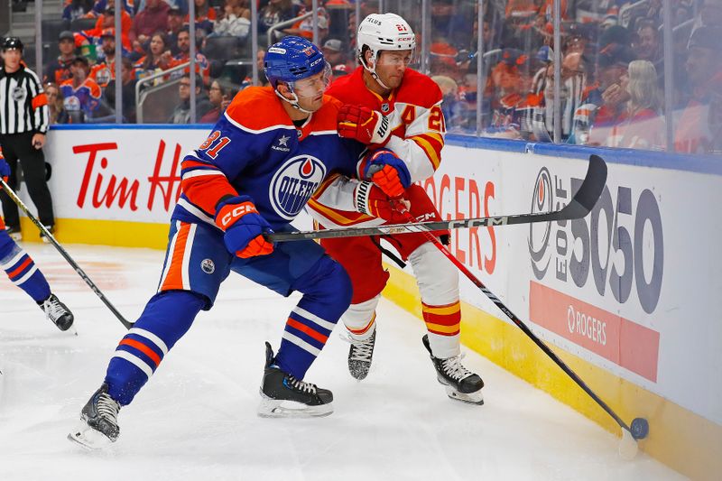 Sep 23, 2024; Edmonton, Alberta, CAN; Edmonton Oilers defensemen Noel Hoefenmayer (81) checks Calgary Flames forward Kevin Rooney (21) during the second period at Rogers Place. Mandatory Credit: Perry Nelson-Imagn Images