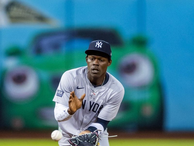 Sep 20, 2024; Oakland, California, USA; New York Yankees third baseman Jazz Chisholm Jr. (13) fields a grounder during the third inning against the Oakland Athletics at Oakland-Alameda County Coliseum. Mandatory Credit: Bob Kupbens-Imagn Images