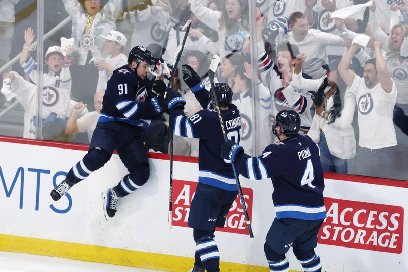 May 4, 2025; Winnipeg, Manitoba, CAN; Winnipeg Jets center Cole Perfetti (91) celebrates after his goal against the St. Louis Blues with teammates left wing Kyle Connor (81) and defenseman Neal Pionk (4) in the third period in game seven of the first round of the 2025 Stanley Cup Playoffs at Canada Life Centre. Mandatory Credit: James Carey Lauder-Imagn Images