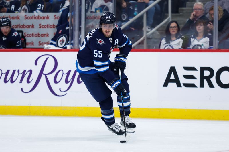 Oct 2, 2024; Winnipeg, Manitoba, CAN;  Winnipeg Jets forward Mark Scheifele (55) skates into the Calgary Flames zone during the second period at Canada Life Centre. Mandatory Credit: Terrence Lee-Imagn Images