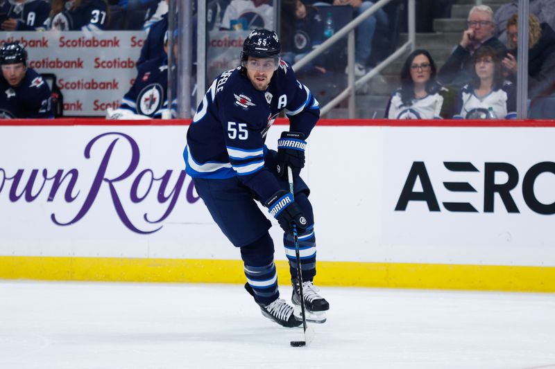 Oct 2, 2024; Winnipeg, Manitoba, CAN;  Winnipeg Jets forward Mark Scheifele (55) skates into the Calgary Flames zone during the second period at Canada Life Centre. Mandatory Credit: Terrence Lee-Imagn Images