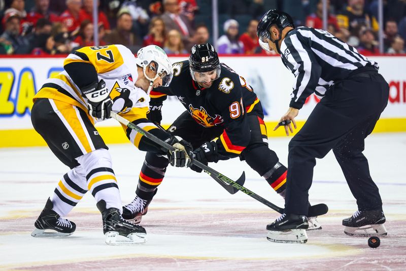 Oct 22, 2024; Calgary, Alberta, CAN; Calgary Flames center Nazem Kadri (91) and Pittsburgh Penguins center Sidney Crosby (87) face off for the puck during the overtime period at Scotiabank Saddledome. Mandatory Credit: Sergei Belski-Imagn Images