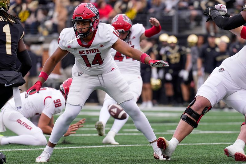 Nov 11, 2023; Winston-Salem, North Carolina, USA; North Carolina State Wolfpack tight end Cedd Seabrough (14) blocks on special teams as place kicker Brayden Narveson (44) adds an extra point during the first half against the Wake Forest Demon Deacons at Allegacy Federal Credit Union Stadium. Mandatory Credit: Jim Dedmon-USA TODAY Sports