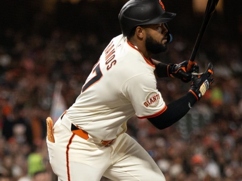 Sep 22, 2025; San Francisco, California, USA; San Francisco Giants left fielder Heliot Ramos (17) follows through on his two-run single against the St. Louis Cardinals during the fourth inning at Oracle Park. Mandatory Credit: D. Ross Cameron-Imagn Images