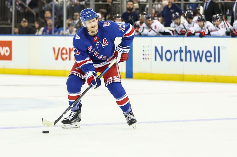 Oct 12, 2025; New York, New York, USA;  New York Rangers defenseman Adam Fox (23) looks to make a pass during a power play in the second period against the Washington Capitals at Madison Square Garden. Mandatory Credit: Wendell Cruz-Imagn Images