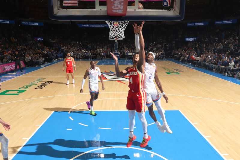 OKLAHOMA CITY, OK - OCTOBER 17: Kobe Bufkin #4 of the Atlanta Hawks drives to the basket during the game against the Oklahoma City Thunder on October 17, 2024 at Paycom Arena in Oklahoma City, Oklahoma. NOTE TO USER: User expressly acknowledges and agrees that, by downloading and or using this photograph, User is consenting to the terms and conditions of the Getty Images License Agreement. Mandatory Copyright Notice: Copyright 2024 NBAE (Photo by Zach Beeker/NBAE via Getty Images)