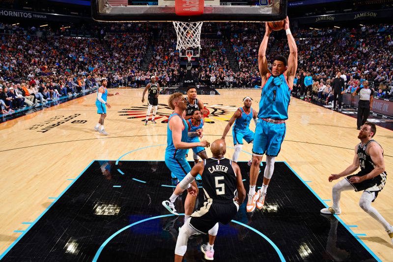 PHOENIX, AZ - MARCH 14: Devin Booker #1 of the Phoenix Suns grabs a rebound against the Milwaukee Bucks on March 14, 20223at Footprint Center in Phoenix, Arizona. NOTE TO USER: User expressly acknowledges and agrees that, by downloading and or using this photograph, user is consenting to the terms and conditions of the Getty Images License Agreement. Mandatory Copyright Notice: Copyright 2023 NBAE (Photo by Barry Gossage/NBAE via Getty Images)