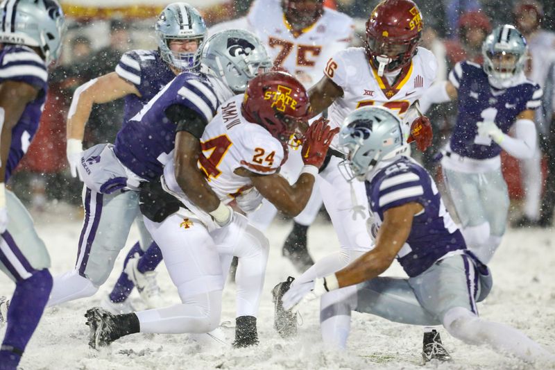 Nov 25, 2023; Manhattan, Kansas, USA; Iowa State Cyclones running back Abu Sama III (24) is tackled by Kansas State Wildcats safety VJ Payne (19) and safety Marques Sigle (21) during the fourth quarter at Bill Snyder Family Football Stadium. Mandatory Credit: Scott Sewell-USA TODAY Sports