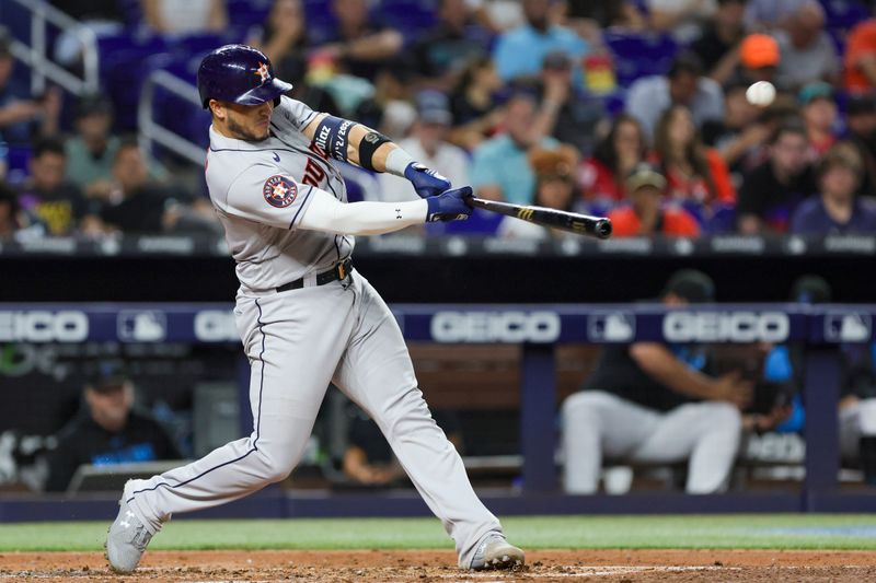 Aug 15, 2023; Miami, Florida, USA; Houston Astros catcher Yainer Diaz (21) hits a two-run home run against the Miami Marlins during the fourth inning at loanDepot Park. Mandatory Credit: Sam Navarro-USA TODAY Sports