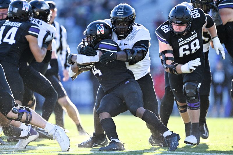 Nov 18, 2023; Evanston, Illinois, USA;  Purdue Boilermakers defensive lineman Cole Brevard (91) tackles Northwestern Wildcats running back Cam Porter (4) in the fourth quarter at Ryan Field. Mandatory Credit: Jamie Sabau-USA TODAY Sports