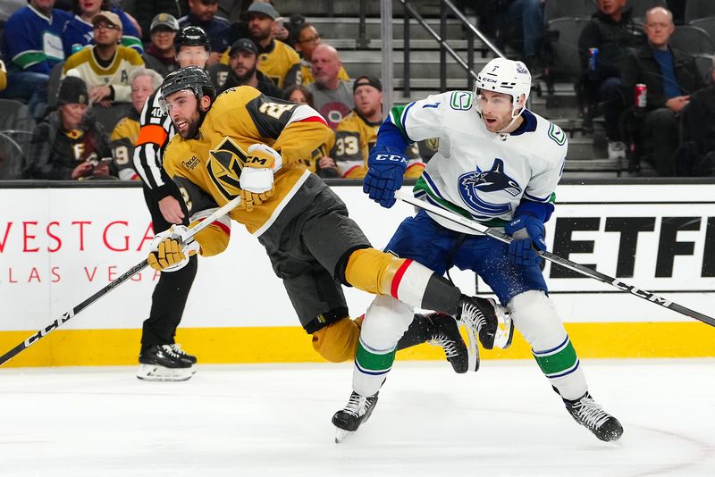 Mar 7, 2024; Las Vegas, Nevada, USA; Vegas Golden Knights right wing Michael Amadio (22) is tripped by Vancouver Canucks defenseman Carson Soucy (7) during the second period at T-Mobile Arena. Mandatory Credit: Stephen R. Sylvanie-USA TODAY Sports