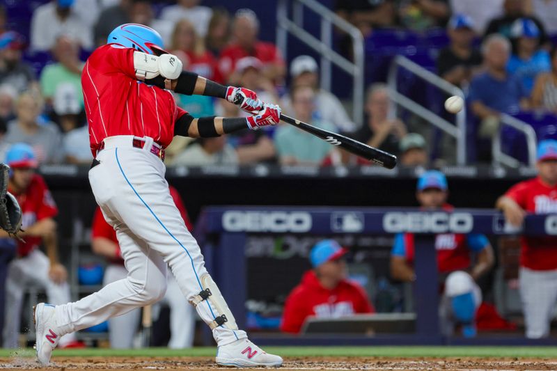 Jul 22, 2023; Miami, Florida, USA; Miami Marlins second baseman Luis Arraez (3) hits a double against the Colorado Rockies during the third inning at loanDepot Park. Mandatory Credit: Sam Navarro-USA TODAY Sports