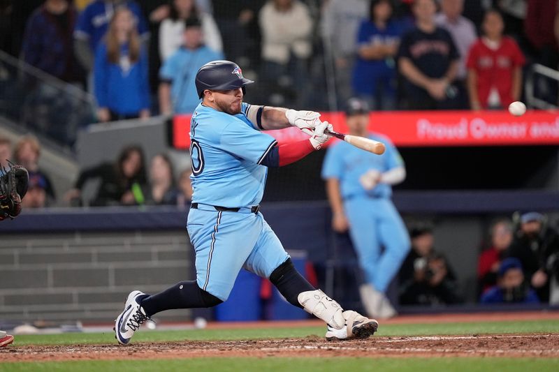 Apr 30, 2025; Toronto, Ontario, CAN; Toronto Blue Jays catcher Alejandro Kirk (30) hits an RBI walk-off single against the Boston Red Sox during the tenth inning at Rogers Centre. Mandatory Credit: John E. Sokolowski-Imagn Images