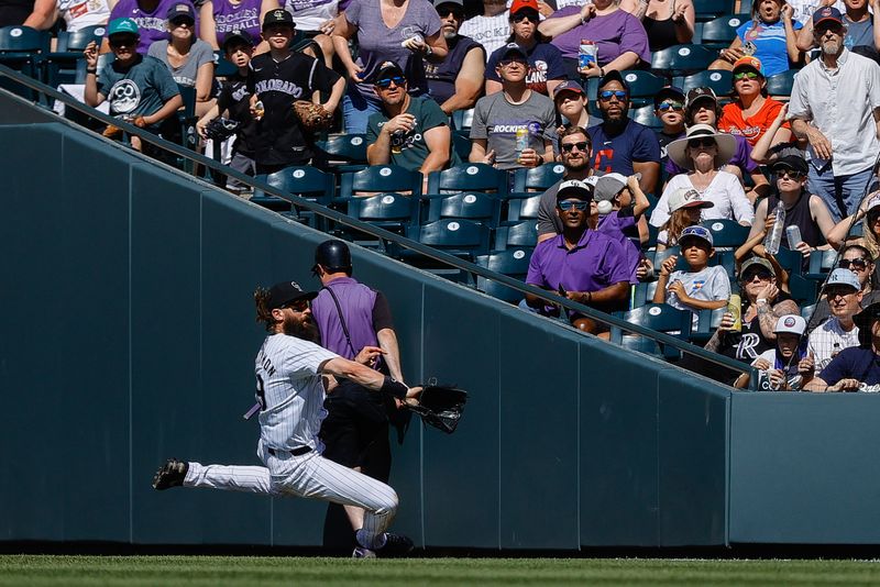 May 27, 2024; Denver, Colorado, USA; Colorado Rockies right fielder Charlie Blackmon (19) makes a sliding catch in the sixth inning against the Cleveland Guardians at Coors Field. Mandatory Credit: Isaiah J. Downing-USA TODAY Sports