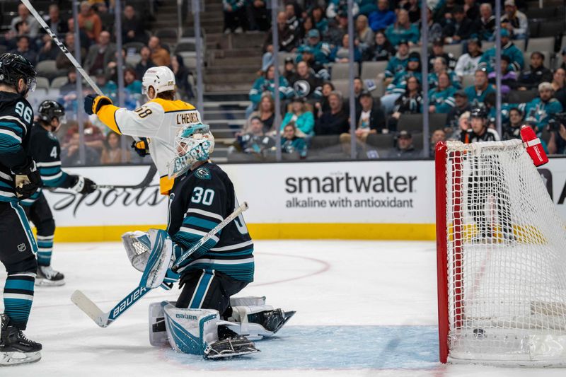 Jan 23, 2025; San Jose, California, USA;  San Jose Sharks goaltender Yaroslav Askarov (30) reacts after Nashville Predators score during the third period at SAP Center at San Jose. Mandatory Credit: Neville E. Guard-Imagn Images