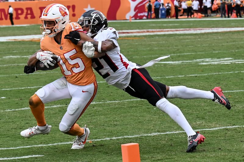 Atlanta Falcons safety Richie Grant (27) hits Tampa Bay Buccaneers wide receiver Jalen McMillan (15) during the second half of an NFL football game, Sunday, Oct. 27, 2024, in Tampa. (AP Photo/Jason Behnken)