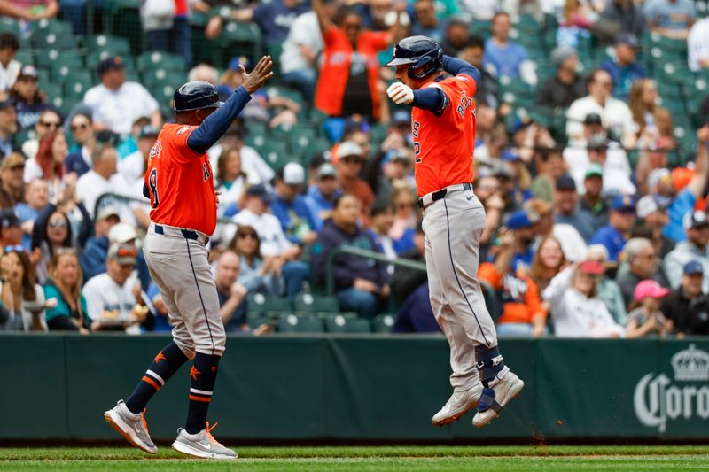 May 30, 2024; Seattle, Washington, USA; Houston Astros third baseman Alex Bregman (2) celebrates with third base coach Gary Pettis (8) after hitting a two-run home run against the Seattle Mariners during the fourth inning at T-Mobile Park. Mandatory Credit: Joe Nicholson-USA TODAY Sports