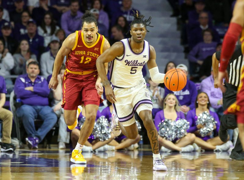 Feb 18, 2023; Manhattan, Kansas, USA; Kansas State Wildcats guard Cam Carter (5) steals the ball from Iowa State Cyclones forward Robert Jones (12) during the first half at Bramlage Coliseum. Mandatory Credit: Scott Sewell-USA TODAY Sports