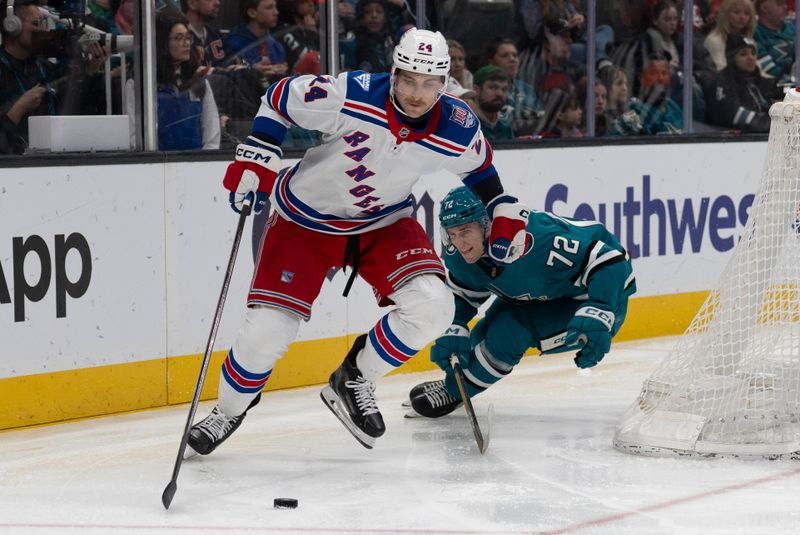 Jan 23, 2026; San Jose, California, USA;  New York Rangers defenseman Carson Soucy (24) and San Jose Sharks left wing William Eklund (72) fight for control of the puck during the second period at SAP Center at San Jose. Mandatory Credit: Stan Szeto-Imagn Images