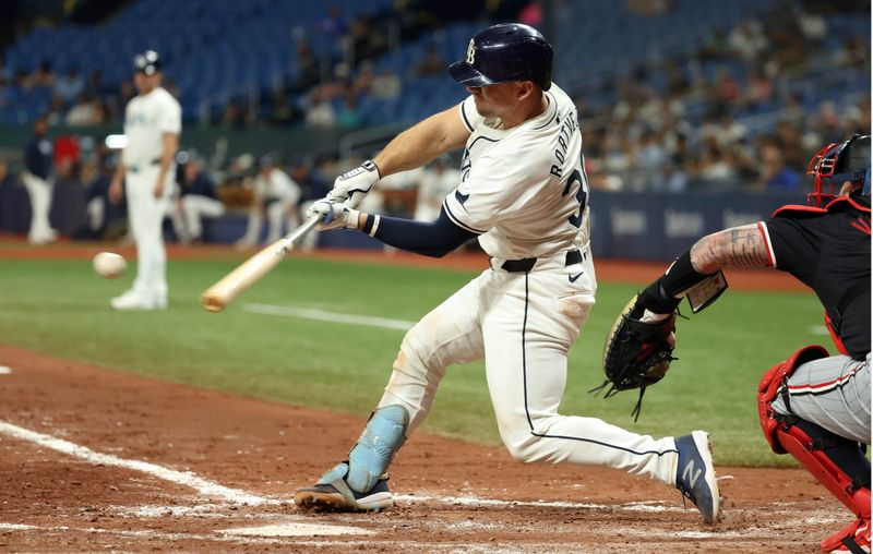 Sep 4, 2024; St. Petersburg, Florida, USA;  Tampa Bay Rays catcher Ben Rortvedt (30) hits an RBI single against the Minnesota Twins during the fourth inning at Tropicana Field. Mandatory Credit: Kim Klement Neitzel-Imagn Images