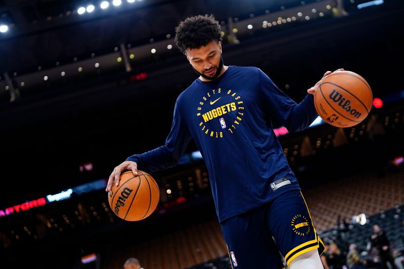 TORONTO, CANADA - OCTOBER 28: Jamal Murray #27 of the Denver Nuggets smiles during the warm up before the game against the Toronto Raptors on October 28, 2024 at the Scotiabank Arena in Toronto, Ontario, Canada.  NOTE TO USER: User expressly acknowledges and agrees that, by downloading and or using this Photograph, user is consenting to the terms and conditions of the Getty Images License Agreement.  Mandatory Copyright Notice: Copyright 2024 NBAE (Photo by Mark Blinch/NBAE via Getty Images)