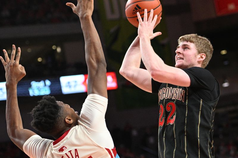 Feb 11, 2023; Lincoln, Nebraska, USA;  Wisconsin Badgers forward Steven Crowl (22) attempts a shot over Nebraska Cornhuskers forward Blaise Keita (15) in the second half at Pinnacle Bank Arena. Mandatory Credit: Steven Branscombe-USA TODAY Sports