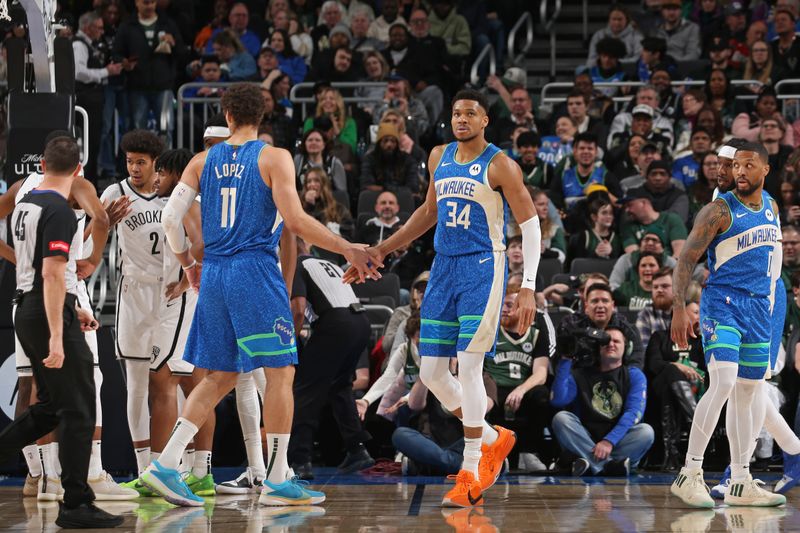 MILWAUKEE, WI - MARCH 21: Giannis Antetokounmpo #34 of the Milwaukee Bucks high fives Brook Lopez #11 during the game against the Brooklyn Nets on March 21, 2024 at the Fiserv Forum Center in Milwaukee, Wisconsin. NOTE TO USER: User expressly acknowledges and agrees that, by downloading and or using this Photograph, user is consenting to the terms and conditions of the Getty Images License Agreement. Mandatory Copyright Notice: Copyright 2024 NBAE (Photo by Gary Dineen/NBAE via Getty Images).