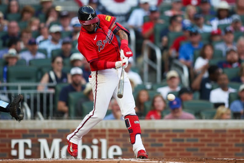 Jun 14, 2024; Atlanta, Georgia, USA; Atlanta Braves shortstop Orlando Arcia (11) hits a single against the Tampa Bay Rays in the first inning at Truist Park. Mandatory Credit: Brett Davis-USA TODAY Sports
