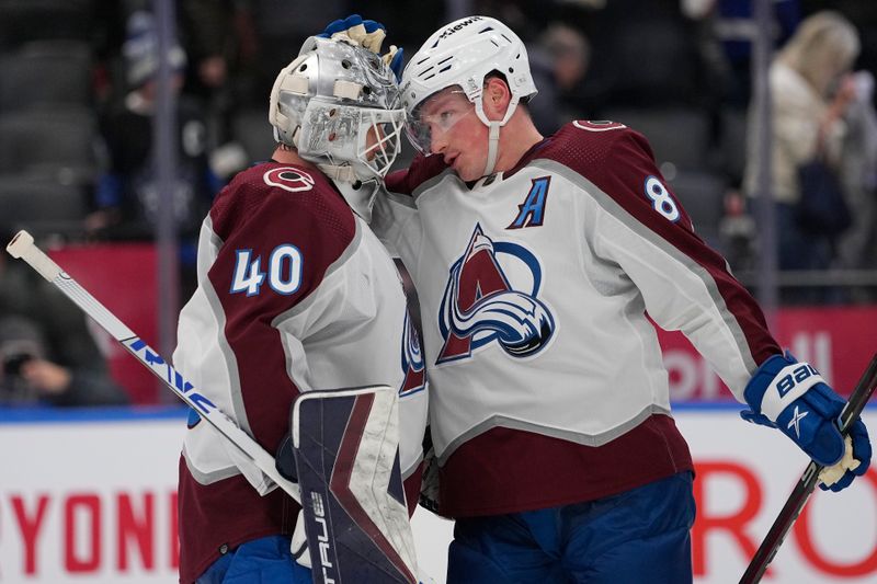 Jan 13, 2024; Toronto, Ontario, CAN; Colorado Avalanche defenseman Cale Makar (8) and goaltender Alexandar Georgiev (40) celebrate a win over the Toronto Maple Leafs during the third period at Scotiabank Arena. Mandatory Credit: John E. Sokolowski-USA TODAY Sports