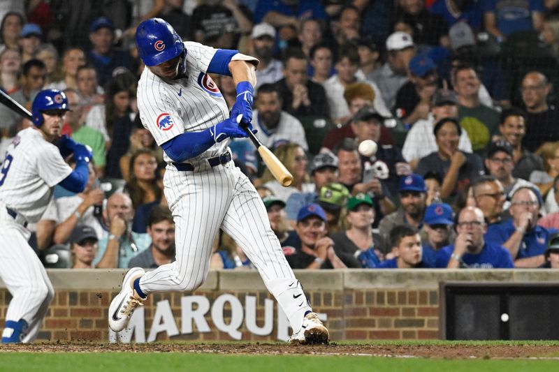 Jul 23, 2024; Chicago, Illinois, USA;  Chicago Cubs second baseman Nico Hoerner (2) doubles against the Milwaukee Brewers during the fifth inning at Wrigley Field. Mandatory Credit: Matt Marton-USA TODAY Sports