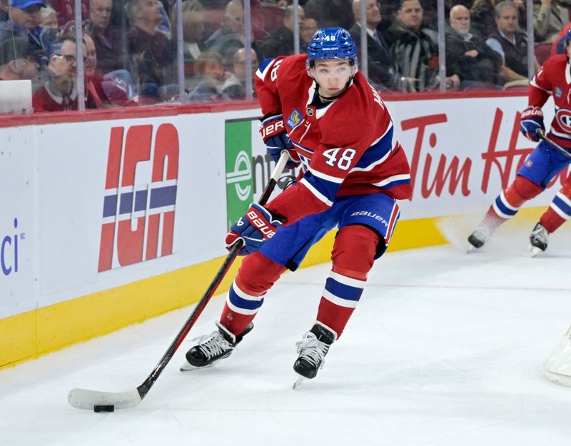 Oct 17, 2024; Montreal, Quebec, CAN; Montreal Canadiens defenseman Lane Hutson (48) plays the puck during the first period of the game against the Los Angeles Kings at the Bell Centre. Mandatory Credit: Eric Bolte-Imagn Images