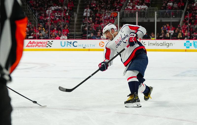 Apr 5, 2024; Raleigh, North Carolina, USA; Washington Capitals left wing Alex Ovechkin (8) takes a shot against the Carolina Hurricanes during the second period at PNC Arena. Mandatory Credit: James Guillory-USA TODAY Sports