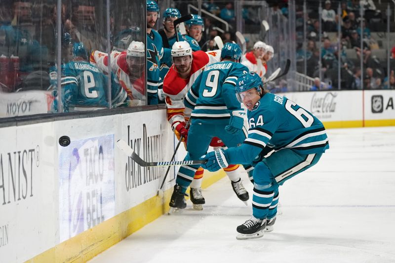 Apr 9, 2024; San Jose, California, USA; San Jose Sharks center Mikael Granlund (64) passes the puck against the Calgary Flames during the third period at SAP Center at San Jose. Mandatory Credit: David Gonzales-USA TODAY Sports