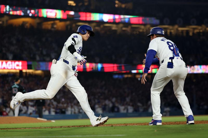 Jul 2, 2024; Los Angeles, California, USA;  Los Angeles Dodgers designated hitter Shohei Ohtani (17) is greeted by first base coach Clayton McCullough (86) after hitting a two-run home run during the seventh inning against the Arizona Diamondbacks at Dodger Stadium. Mandatory Credit: Kiyoshi Mio-USA TODAY Sports