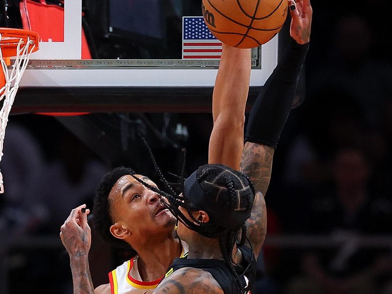 ATLANTA, GEORGIA - FEBRUARY 27:  Kobe Bufkin #4 of the Atlanta Hawks defends against Jordan Clarkson #00 of the Utah Jazz during the second quarter at State Farm Arena on February 27, 2024 in Atlanta, Georgia.  NOTE TO USER: User expressly acknowledges and agrees that, by downloading and/or using this photograph, user is consenting to the terms and conditions of the Getty Images License Agreement.  (Photo by Kevin C. Cox/Getty Images)