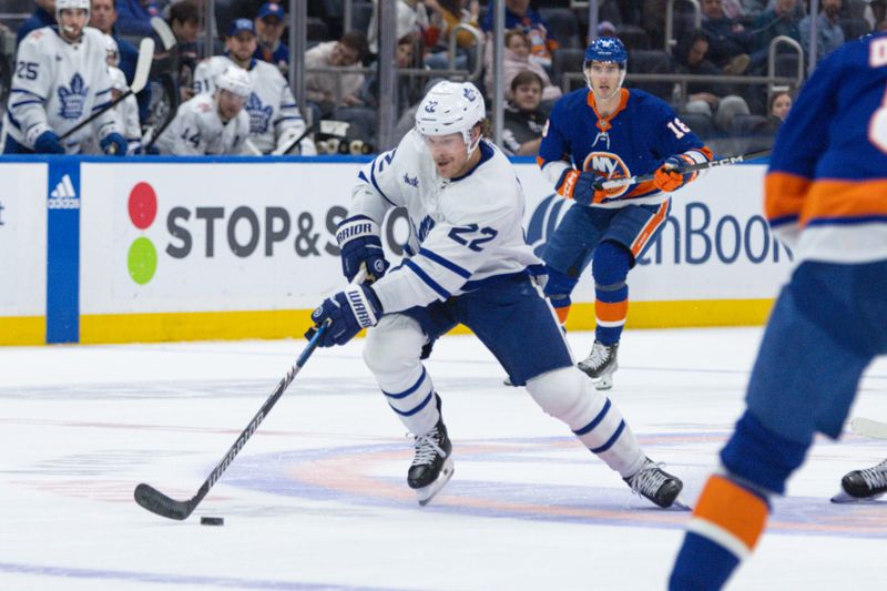 Dec 11, 2023; Elmont, New York, USA; Toronto Maple Leafs defenseman Jake McCabe (22) skates with the puck against the New York Islanders during the first period at UBS Arena. Mandatory Credit: Thomas Salus-USA TODAY Sports