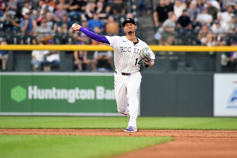 Aug 16, 2025; Denver, Colorado, USA; Colorado Rockies shortstop Ezequiel Tovar (14) makes an out during the fourth inning against the Arizona Diamondbacks at Coors Field. Mandatory Credit: Christopher Hanewinckel-Imagn Images