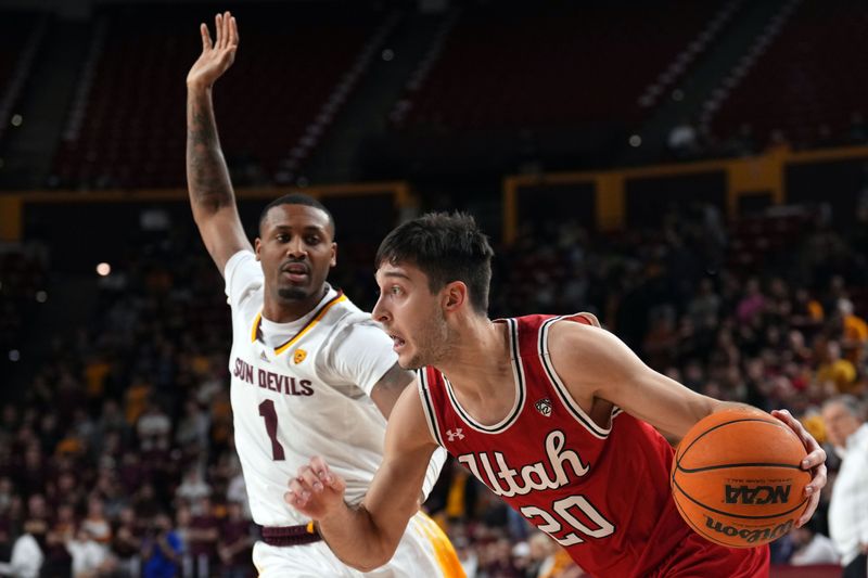 Feb 18, 2023; Tempe, Arizona, USA; Utah Utes guard Lazar Stefanovic (20) drives against Arizona State Sun Devils guard Luther Muhammad (1) during the first half at Desert Financial Arena. Mandatory Credit: Joe Camporeale-USA TODAY Sports