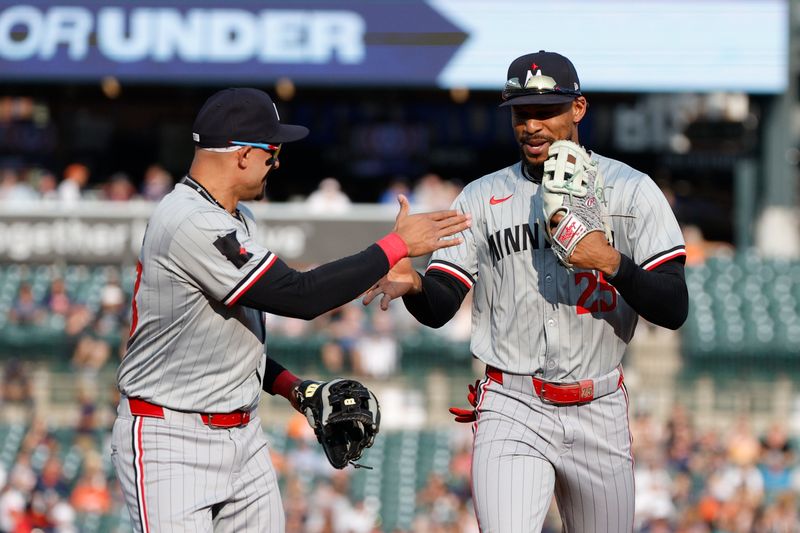 Jul 26, 2024; Detroit, Michigan, USA; Minnesota Twins outfielder Byron Buxton (25) high-fives third baseman Royce Lewis (23) after the first inning of the game against the Detroit Tigers at Comerica Park. Mandatory Credit: Brian Bradshaw Sevald-USA TODAY Sports