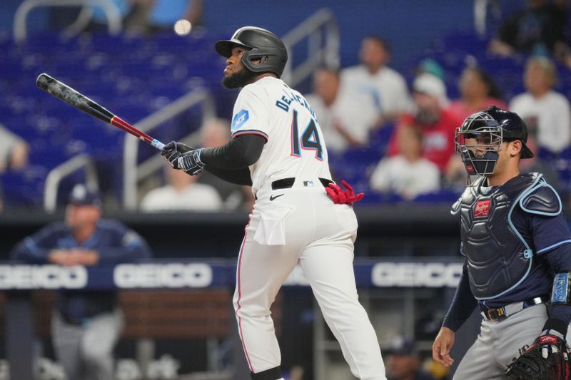 Jun 4, 2024; Miami, Florida, USA; Miami Marlins designated hitter Bryan De La Cruz (14) watches his solo home run leave the ballpark against the Tampa Bay Rays at loanDepot Park. Mandatory Credit: Jim Rassol-USA TODAY Sports